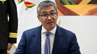 Bolivia's Paz forced to fire economy minister in mid-crisis