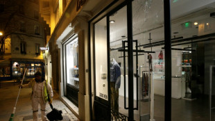 French climate activists target store lights in Paris night raids