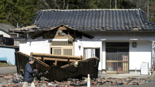 Residents survey damage after powerful Japan quake